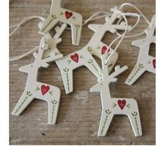 wooden reindeer ornament with red hearts on them