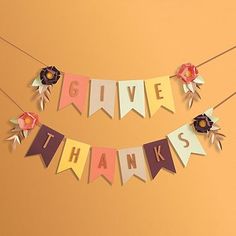 a banner that says give thanks with flowers on it