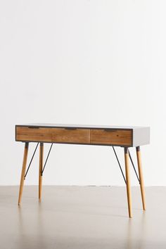 a wooden table with two drawers on it and some legs in front of the desk