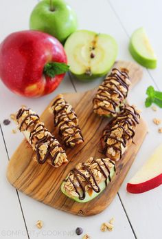 apple slices with chocolate drizzled on them and an apple next to it