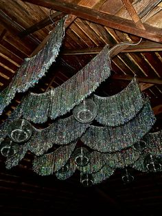 a chandelier hanging from the ceiling in a barn