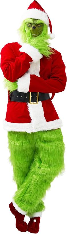 a man dressed in green and red is standing with his arms behind his back while wearing a santa claus costume