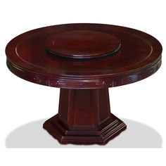 a round wooden table sitting on top of a white floor