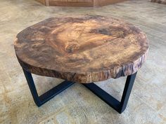 a wooden table sitting on top of a tiled floor