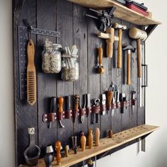 a wall mounted tool rack filled with lots of different types of tools on it's sides