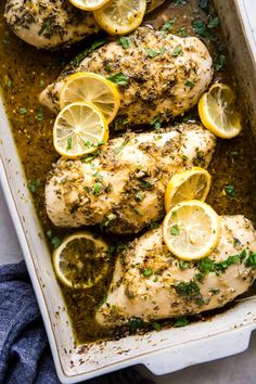 chicken with lemons and herbs in a pan