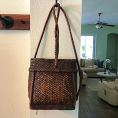 a wicker purse hanging on the wall