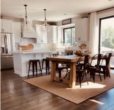 an open kitchen and dining room with wood flooring