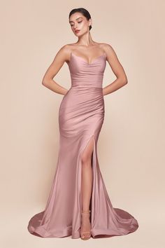 The Ava Gown showcases a strapless pointed V-neckline, a gathered waist, and a stylish leg slit, creating an elegant silhouette. Crafted from stretch spandex satin, it ensures a flawless fit with a lace-up corset back closure. Perfect for bridesmaids, wedding guests, and formal occasions, this dress radiates sophistication. -Silhouette: Fitted -Design: Strapless pointed V-neckline, gathered waistline, leg slit -Fabric & Material: Stretch spandex satin -Fit Detail: Fitted with lace-up corset back Horsehair Hem, Fitted Gowns, Colorful Dresses Formal, Cinderella Divine, Satin Evening Dresses, Corset Back, 21st Dresses, Evening Dresses Cocktail, Usa Dresses