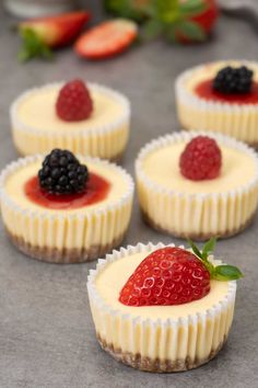 mini cheesecakes with berries on top and the title overlay reads mini cheesecakes