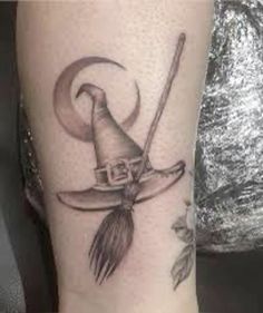 a black and white photo of a witch's hat with a broom