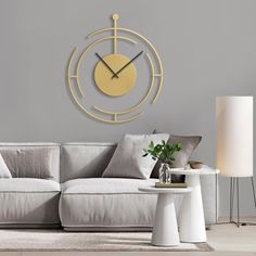 a living room with a couch, table and large clock on the wall above it