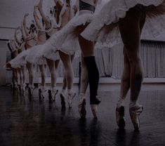 there are many ballet dancers in line with their feet on the dancefloors