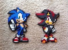 two pixelated sonic the hedgehog magnets sitting on top of a white carpet