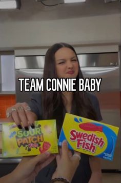 a woman holding two boxes of swedish fish in her hands with the caption team connie baby