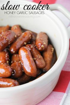 a bowl filled with honey garlic sausages on top of a red and white checkered table cloth