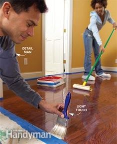 a man is cleaning the floor with a brush and broom while a woman looks on