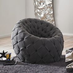 a grey chair sitting on top of a gray rug