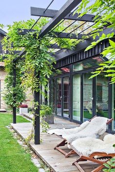 an outdoor area with lawn chairs and plants