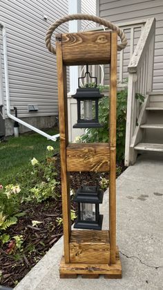 a wooden lantern holder with three lanterns on it