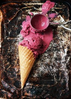 two scoops of ice cream sit on an old tray