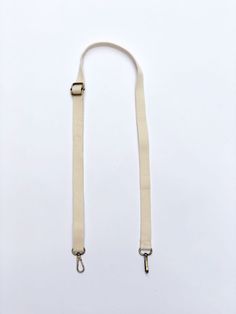 "Add some extra style to your Bodomint Bag with this colorful webbing strap. It's adjustable length and convenient clips work with any bag--so you can mix & match it to your heart's content. - Cotton canvas webbing. - Antique brass hardware. - 27\"L at shortest to 49\"L x 3/4\"W. - Pairs perfectly with any Bodomint Bag. - Can also be worn as a belt with the Bodomint Bowie Pack." Everyday Adjustable White Bag Strap, Everyday White Adjustable Bag Strap, Adjustable White Shoulder Strap For Everyday Use, Beige Logo Shoulder Strap For Everyday Use, White Adjustable Shoulder Strap For Everyday Use, Adjustable Casual Shoulder Strap For Travel, Casual Adjustable Shoulder Strap For Travel, Casual Bag Strap With Adjustable Straps, Casual Bag Strap With Adjustable Straps For Everyday Use