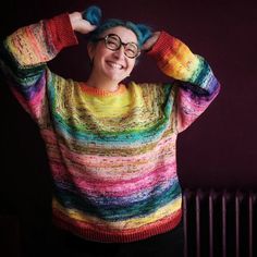 a woman wearing glasses and a colorful sweater