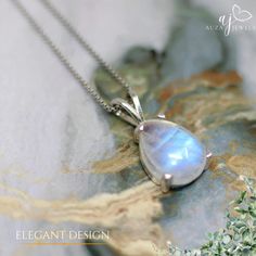 A moonstone silver pendant is a delicate piece of jewelry that combines the ethereal beauty of moonstone with the timeless elegance of sterling silver. The moonstone, known for its pearly sheen and mesmerizing inner glow, is often described as having a moonlit quality. This soft luminescence is caused by a phenomenon called adularescence, which creates a play of light within the gemstone. The silver setting complements the moonstone's subtle brilliance. It can be a simple and modern bezel setting that allows the moonstone to take center stage, or a more intricate design with swirling vines or crescent moon motifs that echo the stone's celestial connection. Moonstone pendants come in a variety of shapes and sizes. Round and oval cuts are classic choices, while pear or teardrop shapes add a Elegant Teardrop Moonstone Ring, Silver Moonstone Teardrop Pendant, Silver Moonstone Teardrop Pendant Jewelry, Moon-shaped Moonstone Jewelry In White Gold, Delicate Moonstone Jewelry For Anniversary, Elegant Silver Moon Jewelry, Elegant Silver Moon-shaped Jewelry, White Gold Moon-shaped Moonstone Jewelry, Formal Moon Phase Sterling Silver Jewelry