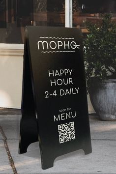 a sign that says happy hour 24 - daily on the sidewalk in front of a restaurant