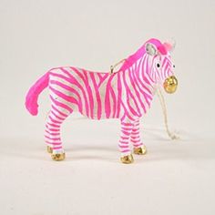 a pink and white zebra ornament with bells on it's head, standing upright