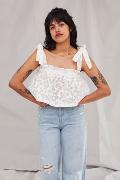 This flowy crop top is the perfect basic for adding a pretty pop to your off-the-clock ensembles. Featuring an elastic bust and adjustable tie straps, this top is cropped at just the right spot to pair with your high-waisted jeans. Details Each piece is individually hand-dyed—color and pattern may vary per garment. Content + Care - Hand wash, line dry - Made in the USA Size + Fit Size 1 Size 2 White Flowy Crop Top, Soft-washed White Fun Top, Tie Dye Fitted Cotton Crop Top, Tie-dye Cropped Cotton Tops, Spring Tie-dye Washed Top, Jeans Details, Flowy Crop Top, Crop Tee, Mens Bottom