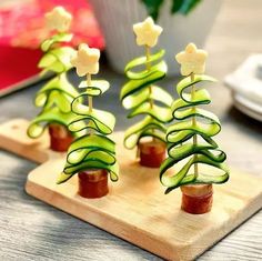 cucumber christmas trees are on a cutting board