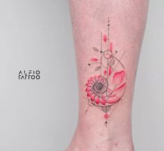 a woman's foot with a red flower tattoo on the side of her leg