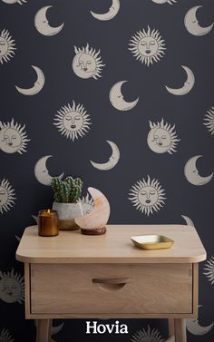 the sun and moon wallpaper in this room is perfect for any space that needs to be occupied