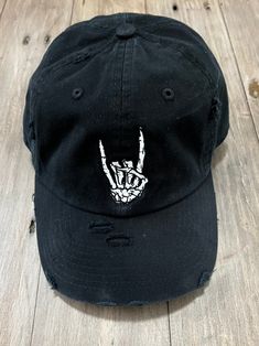 Rock on Skeleton Hand Embroidered Distressed Hat! Black Distressed Baseball Hat! Printing process is Embroidery All hats are made to order. Vintage Distressed Washed Style. 100% Cotton Made. Lightweight / Durable / Smooth. Adjustable Metal Buckle Back Closure, Great Fit for Most Head Sizes. Dad Hat, Low Profile Unconstructed. STAY SAFE UNDER THE SUMMER SUN: Protect your skin from harmful UV rays and keep your hair out of your face and eyes by wearing this comfortable baseball cap during all your Rock On Skeleton Hand, Rock On Skeleton, Embroidered Skeleton, Skeleton Hat, Black Baseball Hat, Grunge Fits, Distressed Hat, Halloween Hats, Embroidered Hat