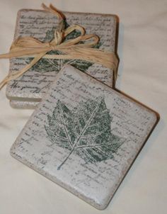 three coasters with leaves on them are tied up and placed next to each other