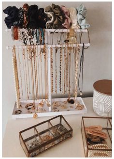 several necklaces and bracelets are on display in a jewelry holder, along with other accessories