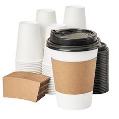 coffee cups with lids and paper napkins on the bottom are lined up against each other