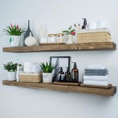 two wooden shelves filled with bathroom items