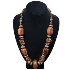 Vintage Tribal Handmade Tigerseye Beaded Necklace - Made of silver tone metal, plastic, wood, and tigerseye gemstone beads - Hook clasp closure - Dimensions: 22" length Good pre-owned condition. Signs of normal wear may be present. Please see all photos for details. Brown Large Beads Costume Jewelry, Wooden Necklaces, Plastic Wood, Wooden Necklace, Hook Clasp, Beaded Necklaces, Gemstone Beads, Necklace Etsy, Silver Tone