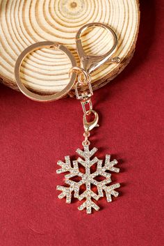 a snowflake shaped keychain on a red background