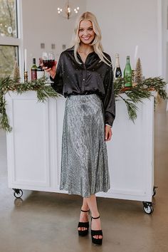 - Shimmering and chic, this gorgeous button up is a perfect touch of glam! - Unlined material with a satin finish - Rhinestone embellishment - A collared neckline - A button-up front - Long, loose sleeves with button closure cuffs - A relaxed silhouette that ends in a rounded hemline