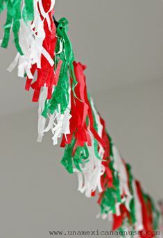 red, white and green streamers hanging from the ceiling