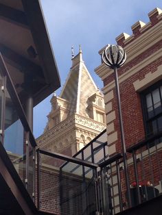 an old building with a clock tower in the background and stairs leading up to it