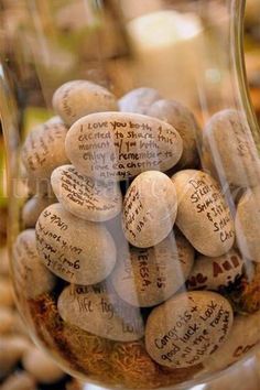 a glass jar filled with lots of rocks and writing on the inside of it's lid