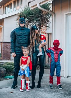 the family is dressed up as batman and robin wayne