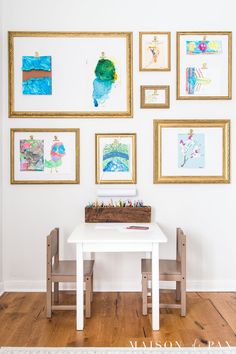 a white table and some pictures on the wall