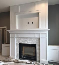 an empty living room with a fireplace in the middle and no one around it on the other side