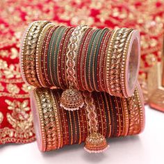 several different types of bracelets and bangles on display in front of a mirror