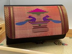 THIS PURSE IS STRONGLY STITCHED WITH GOOD QUALITY OF INNER FABRIC.IT IS A KIND OF CLUTCH, WHICH LOOKS VERY Elegant WITH ANY TRADITIONAL DRESS ALSO GOES WELL WITH ANY CASUAL WEAR. IT HAS A DURABLE METAL CHAIN SO YOU CAN CARRY IT ALONG COMFORTABLY. Specification: Perfect collection for parties, weddings, festivals. Model Name: Purse clutch handicraft pure silk traditional elegant ethnic purse. Color: Hot Pink / Maroon Shape : Round (Same as picture) Fabric : Silk Number of sections : 2 Bag Size - Traditional Festive Rectangular Clutch, Traditional Rectangular Festive Clutch, Traditional Clutch For Diwali, Traditional Multicolor Clutch For Gift, Traditional Multicolor Clutch As A Gift, Multicolor Clutch For Celebration, Traditional Pink Clutch For Formal Occasion, Multicolor Clutch With Zari Work For Celebrations, Rectangular Clutch For Festivals